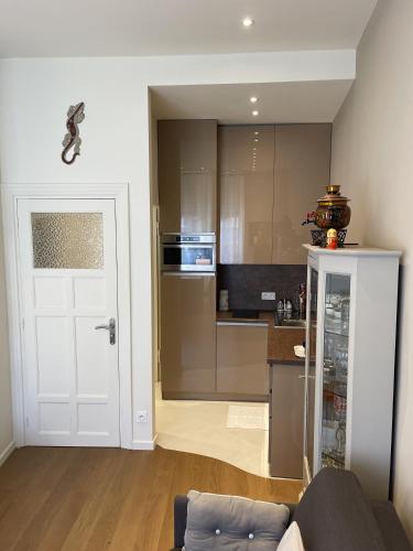 a kitchen with a white door and a kitchen with a counter at Ezevacances Studio Capuccino vue mer 5 mn plage 7 mn gare Wifi in Èze