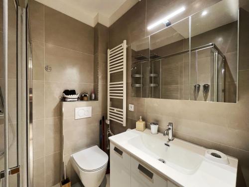 a bathroom with a sink and a toilet at Ezevacances Studio Capuccino vue mer in Éze