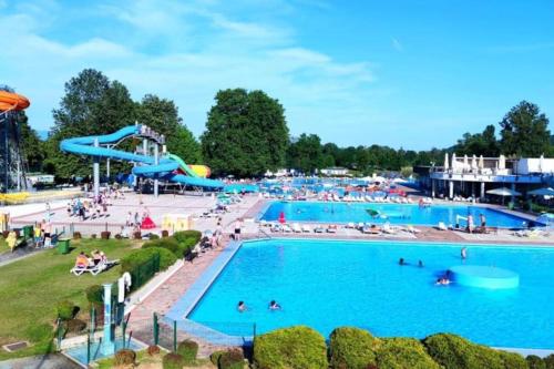 a large swimming pool with a water park at Miabella House - 2 bedrooms and terrace in Brežice