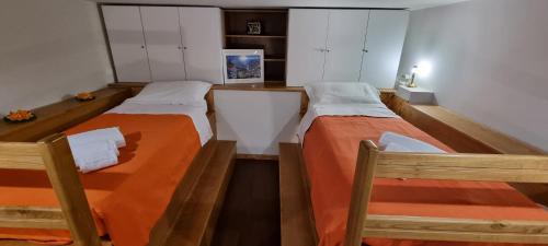 2 Betten in einem kleinen Zimmer mit ermottermottermott in der Unterkunft Casa DON PEPPE in Taormina