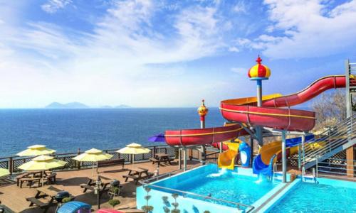 a pool on a cruise ship with a water slide at Buan arco spa pension in Buan