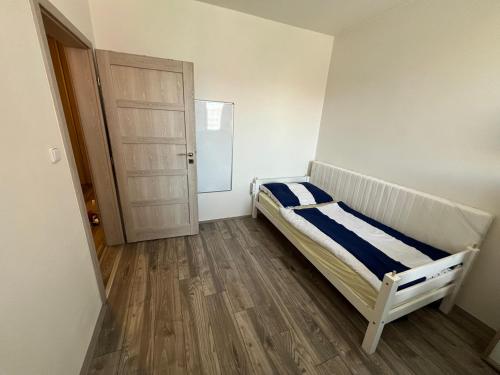 a small bedroom with a bed and a door at Apartment Maluchy in Hrabŭvka