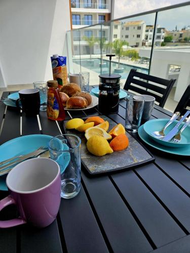 a table with a tray of food and a cup of coffee at Superior Apartment, Universal Residences in Paphos City