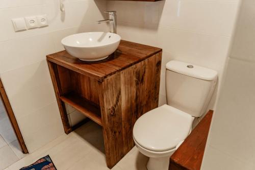 a bathroom with a white sink and a toilet at Long Beach Resort, Nosy Be in Nosy Be