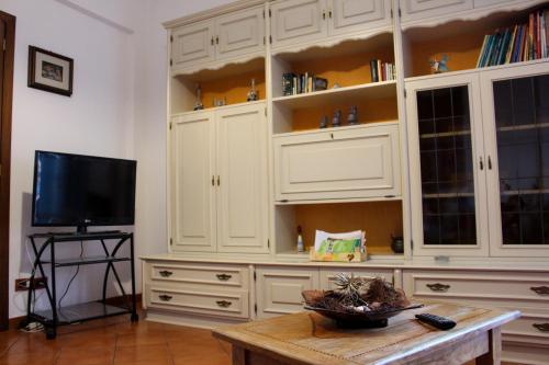 a living room with white cabinets and a tv at Quadrilocale da JO e ANTONIO in Loano
