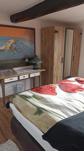 a bedroom with a large bed and a desk at Casa Schönblick & E-Ladestation-Bike Garage in Limburg an der Lahn