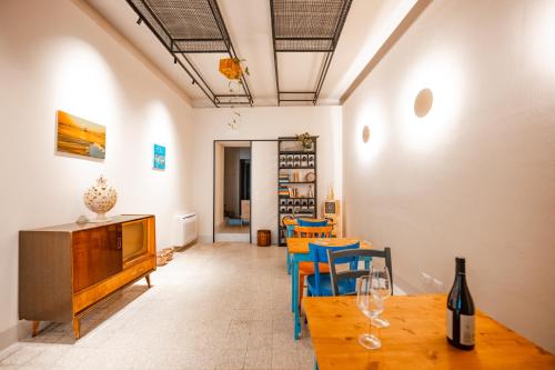 a living room with a table and chairs at DIMORA NIKARE' Sicilian House in Sciacca