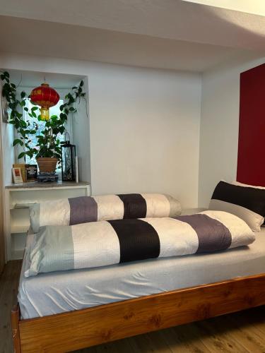 a large bed with several pillows on top of it at Homestay in Waldshut-Tiengen