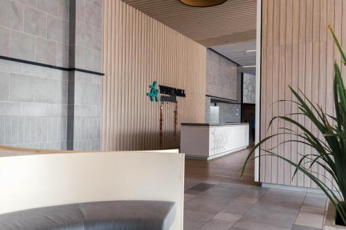 a lobby with a counter and some plants at Windmill Upon Hills Premium Suite By Rapi Stay in Genting Highlands
