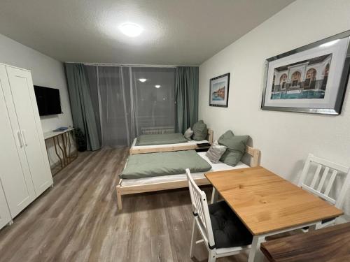 a living room with two beds and a table at Sweet-Home in Hannover