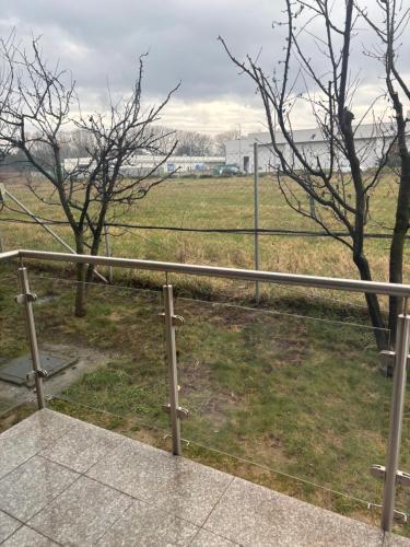 a fence with a view of a field at Class Park Residence in Târgovişte