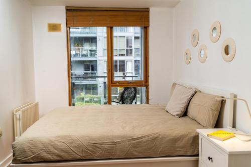 a bedroom with a large bed and a window at Stunning 1 bedroom appartment in Grand Cannal in Dublin