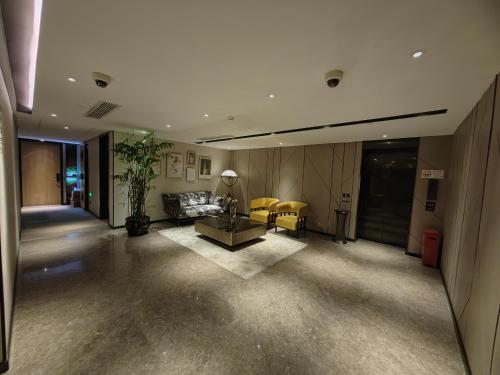 a living room with a couch and a table at Tuke Hotel Shanghai Hongqiao Center Branch in Shanghai