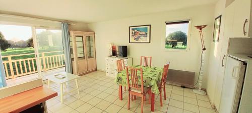 ポルニックにある3 pièces proche plage commerces et golfのダイニングルーム(テーブル、椅子付)、バルコニー