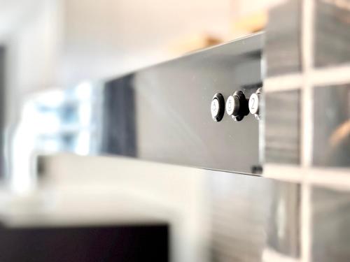 a stove with three knobs on the side of it at STAR BAY Residence Sihanoukville - 400m to Sokha Beach in Sihanoukville