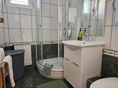 a bathroom with a shower and a sink and a toilet at Adria Apartments and Rooms in Dubrovnik