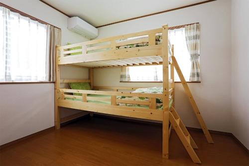 a bunk bed in a room with a ladder at iruka - Vacation STAY 19721v in Nago