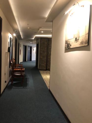 a hallway in a building with a painting on the wall at Hotel Seever in Erbil