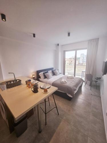 a bedroom with a bed and a table and a table sidx sidx sidx at New, Modern Studio, Universal Residences in Paphos City