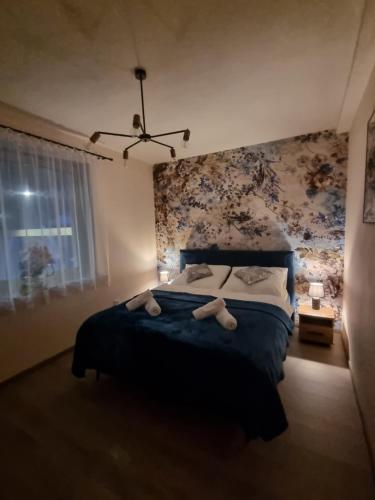 a bedroom with a bed with two teddy bears on it at ZuMiLu House in Zagórz