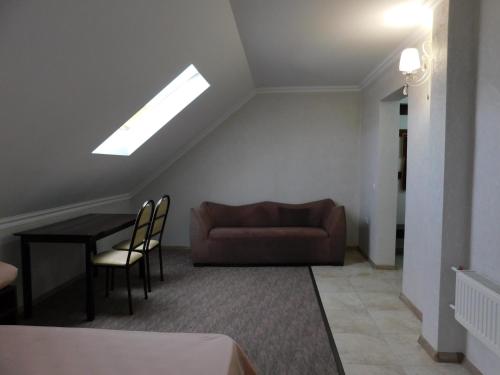 a living room with a couch and a table at Hotel & Banquet Hall SV Airport Parkway in Todoreshty