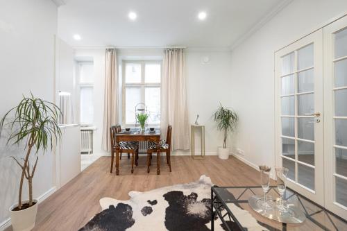 a living room with a table and a couch at Cosy, brand new apartment in best area in Helsinki