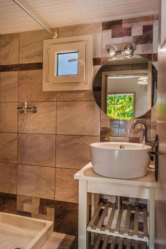 a bathroom with a sink and a mirror at Villa Jasmin Studios 2 in Gouvia