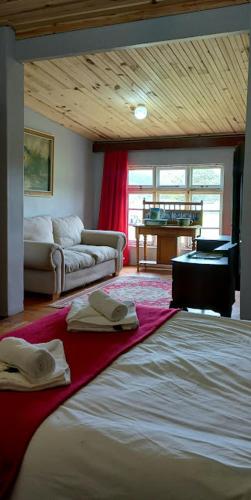 a bedroom with a bed and a living room at The Wild Olive Sanctuary Accommodation in Paterson