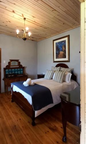 a bedroom with a bed and a wooden ceiling at The Wild Olive Sanctuary Accommodation in Paterson