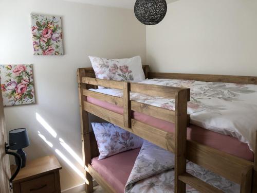 a bedroom with two bunk beds in a room at Bramble cottage with free parking in Bridgnorth