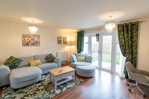 a living room with a couch and two chairs at Pass the Keys Modern comfortable House in Elswick