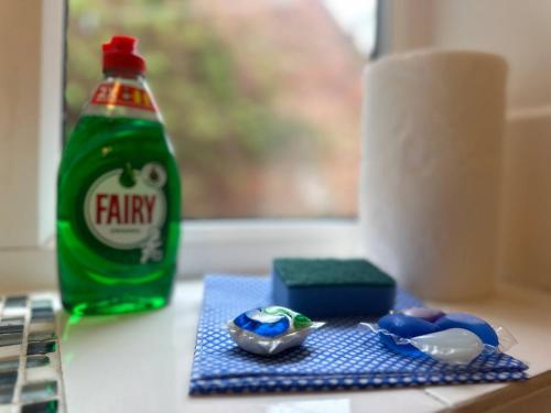 a bottle of soda sitting on a table next to a bowl at Pass the Keys Modern comfortable House in Elswick