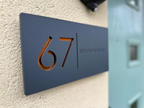 a sign on a wall with the number seven at Pass the Keys Modern comfortable House in Elswick