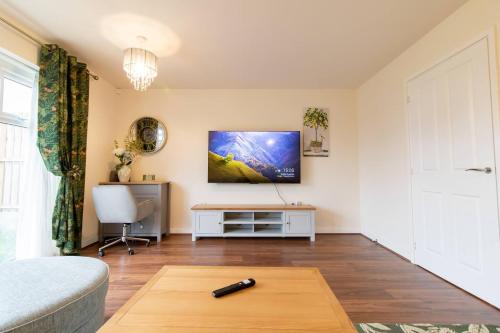 a living room with a gun on a coffee table at Pass the Keys Modern comfortable House in Elswick