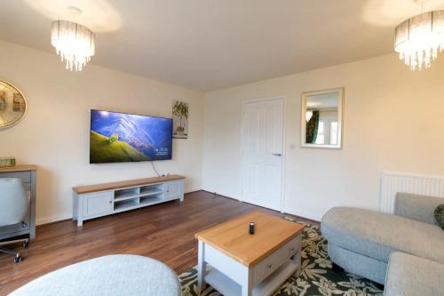 a living room with a couch and a table at Pass the Keys Modern comfortable House in Elswick