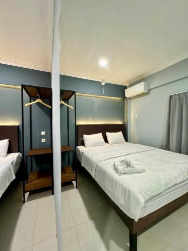 Tempat tidur dalam kamar di Torisan Hotel