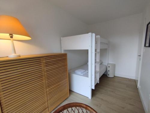 une petite pièce avec un réfrigérateur blanc et une lampe dans l'établissement Appartement pour 4/5 personnes, les pieds dans l'eau, à La Baule