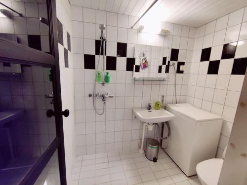La salle de bains est pourvue de toilettes, d'un lavabo et d'une douche. dans l'établissement Yksiö saunalla, à Kuusamo