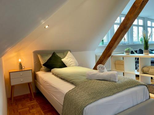 a bedroom with a bed in a attic at Villa Ambiente Falkensee in Falkensee