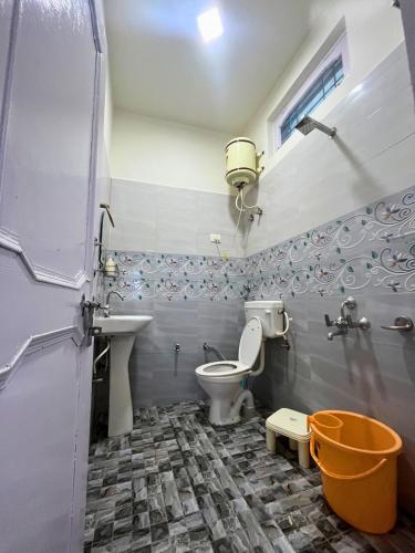 a bathroom with a toilet and a sink at Boho Thikana - Homestay in Bir in Jogindarnagar