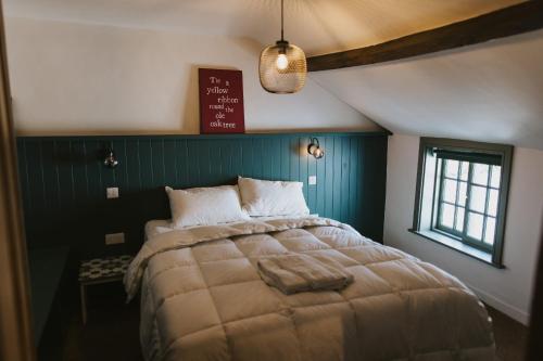 a bedroom with a large bed and a sign on the wall at Cobblers Cottage Brigg in Brigg