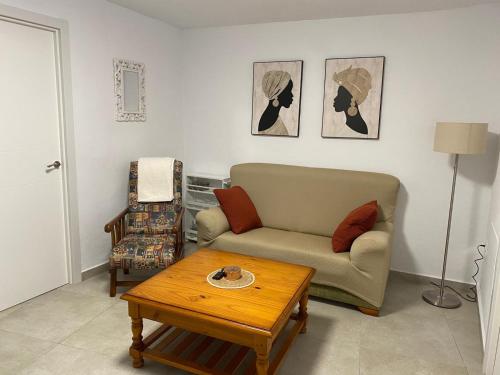 a living room with a couch and a table at La Casa Rosales in Alora