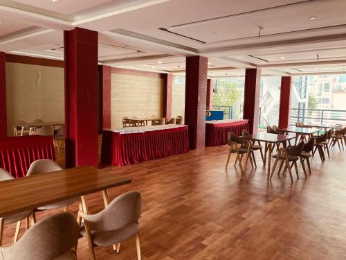 a dining room with tables and chairs in a building at Saksham INN in Jaipur