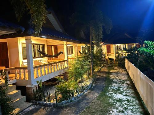 a house at night with a pathway leading to it at Ibiza Bungalows in Haad Yao