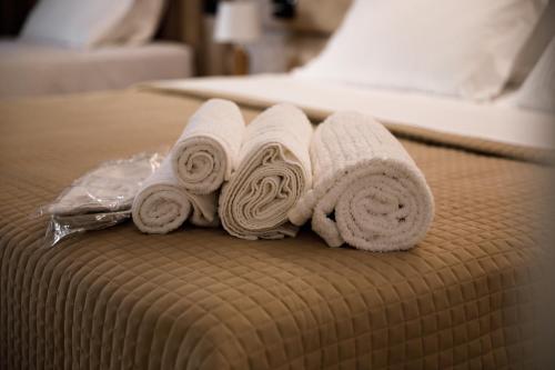 a group of rolled towels on a bed at CastleView Inn in Gjirokastër