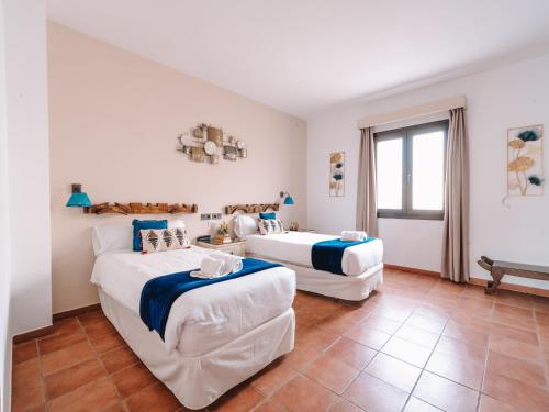 a bedroom with two beds and a window at Hotel Boutique Cerro del Sol Adults only recommended in Granada