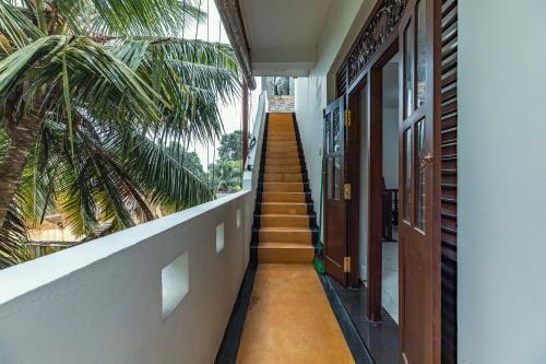 a stairway leading up to a building with a palm tree at Villa Talpe in Talpe