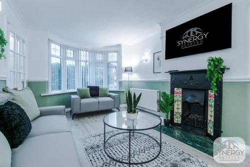 a living room with a couch and a fireplace at Jade House, Manchester - by Synergy Estates in Manchester