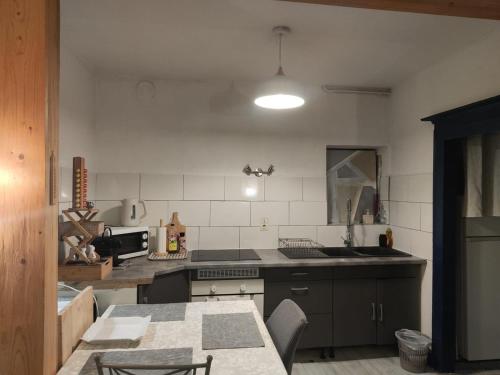 a kitchen with a sink and a table in it at T2 plein centre-ville 40m2 in Albertville