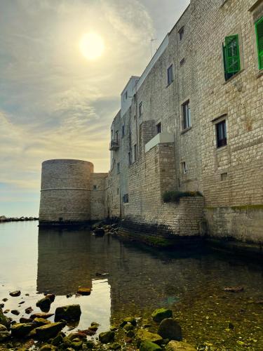 an old building next to a body of water at LA DIMORA casa vacanze di charme in Molfetta